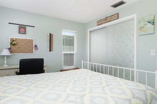 bedroom with a closet and visible vents