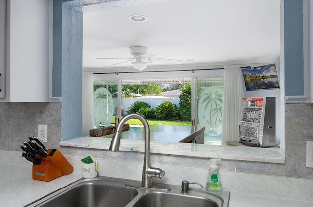 room details featuring a ceiling fan and a sink