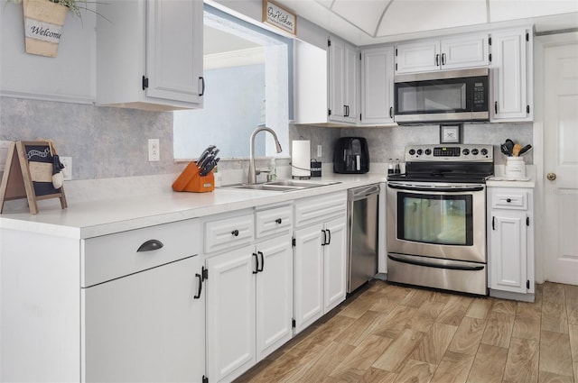 kitchen featuring light countertops, appliances with stainless steel finishes, and white cabinetry