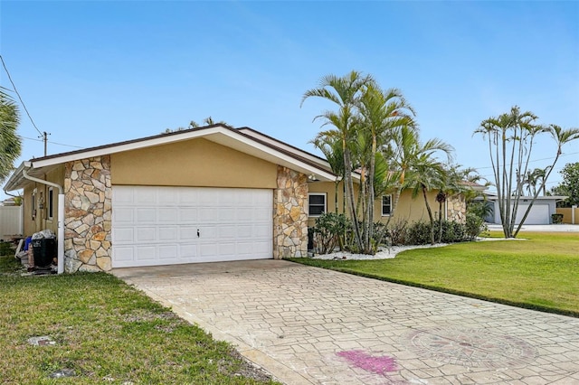 ranch-style house featuring stone siding, a garage, decorative driveway, and stucco siding