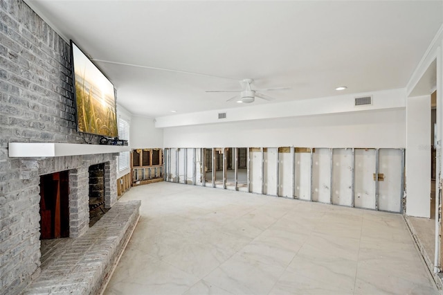 unfurnished living room featuring visible vents, a fireplace, and ceiling fan