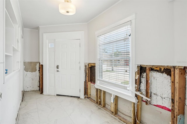 entrance foyer with marble finish floor and ornamental molding