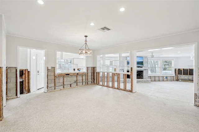 interior space featuring recessed lighting, a brick fireplace, visible vents, and ceiling fan with notable chandelier
