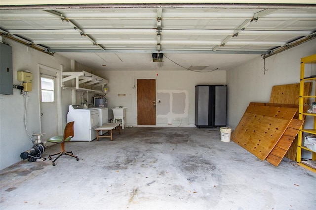 garage featuring a garage door opener, electric panel, a sink, and washer and clothes dryer