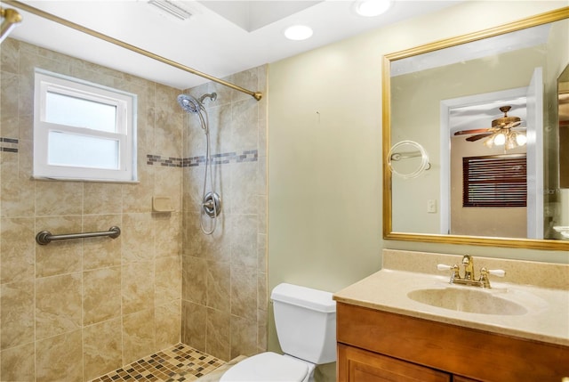 full bath featuring visible vents, toilet, a tile shower, vanity, and recessed lighting