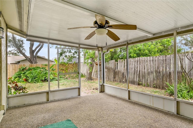 unfurnished sunroom with a ceiling fan