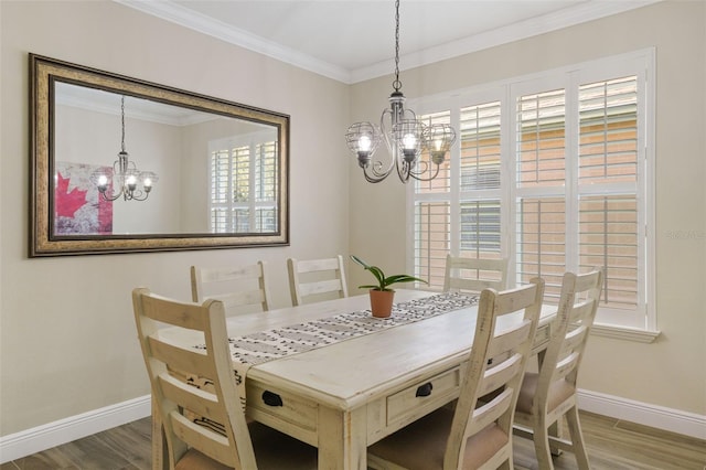 dining space with baseboards, an inviting chandelier, wood finished floors, and ornamental molding