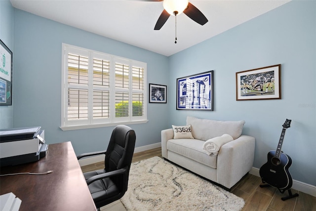 office with baseboards, a ceiling fan, and wood finished floors