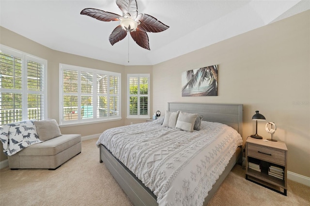 carpeted bedroom featuring baseboards and ceiling fan