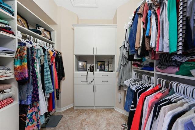 walk in closet featuring attic access