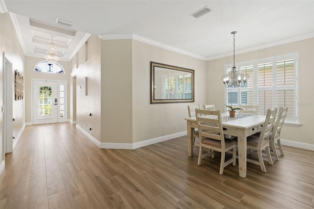 dining area with visible vents, crown molding, baseboards, a chandelier, and wood finished floors