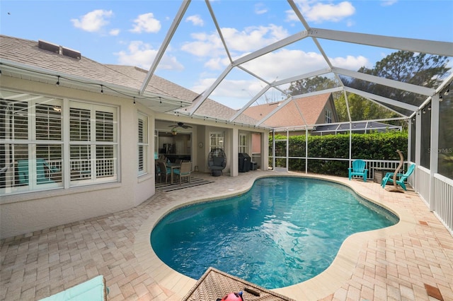 view of pool with a patio area, a fenced in pool, a lanai, and ceiling fan