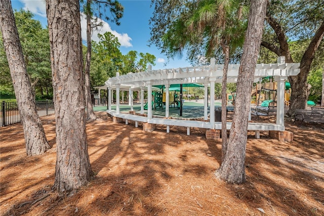 view of home's community with fence and a pergola