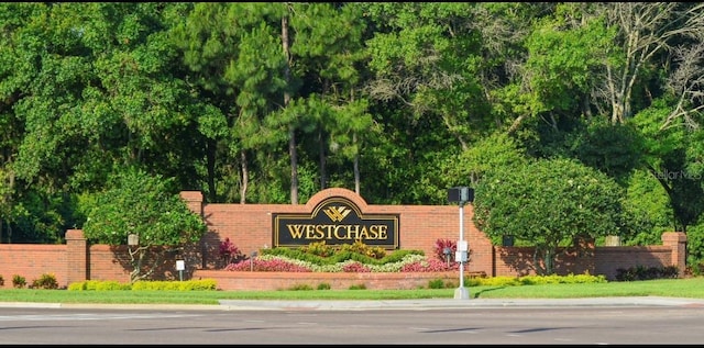 community / neighborhood sign with fence