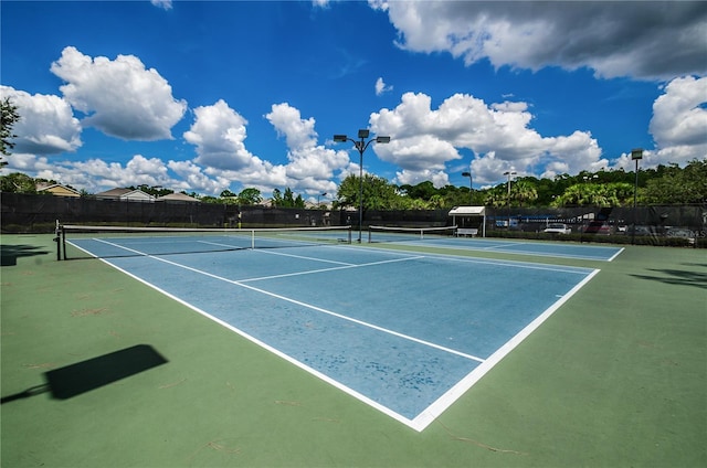 view of tennis court featuring fence