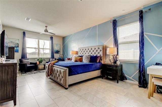 bedroom with light tile patterned floors, visible vents, and ceiling fan