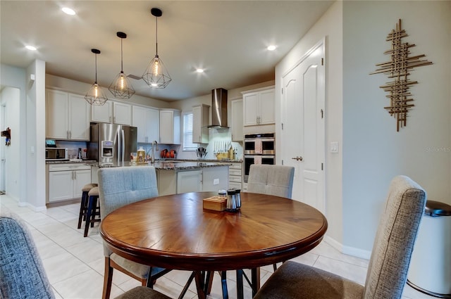 dining space featuring light tile patterned floors, recessed lighting, and baseboards