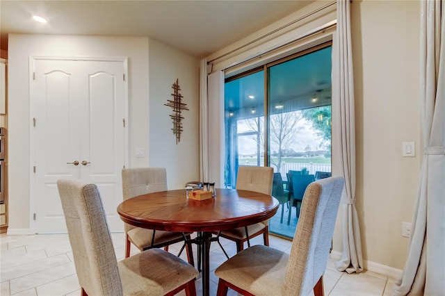 dining room featuring baseboards and light tile patterned flooring