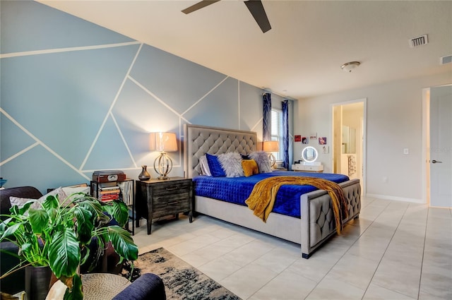 tiled bedroom featuring visible vents, ensuite bath, and a ceiling fan