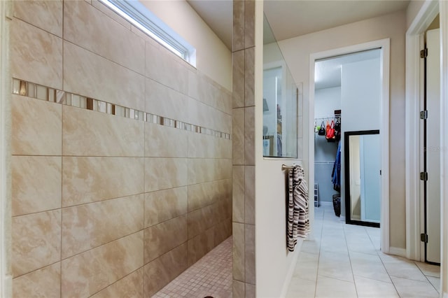 full bathroom with tile patterned floors, a walk in closet, and a walk in shower