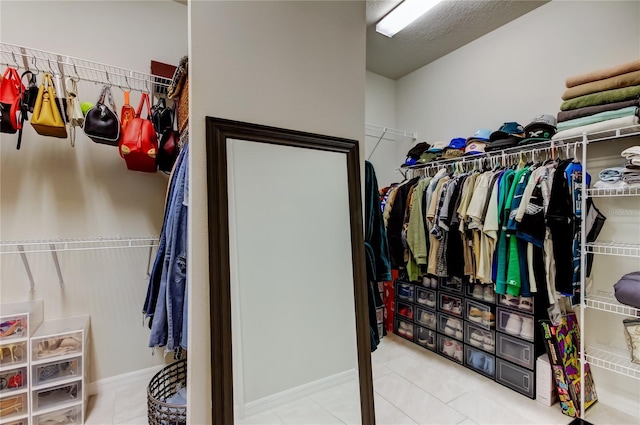 spacious closet with tile patterned floors