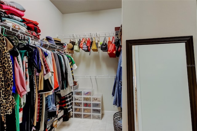 spacious closet featuring tile patterned flooring