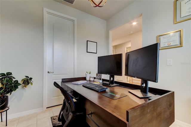 office area with light tile patterned floors and baseboards