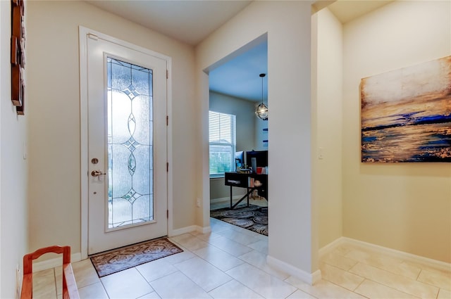 tiled entrance foyer featuring baseboards