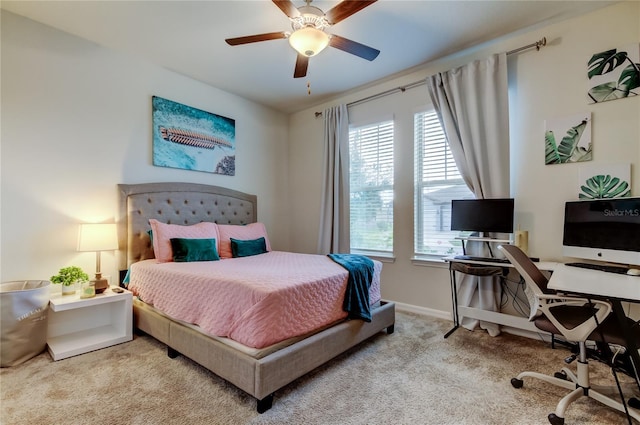 bedroom with a ceiling fan, baseboards, and carpet floors