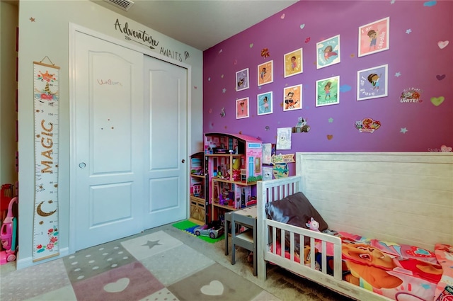 bedroom with tile patterned floors and a closet