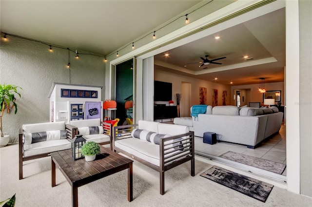 living room featuring tile patterned flooring, a raised ceiling, rail lighting, and recessed lighting