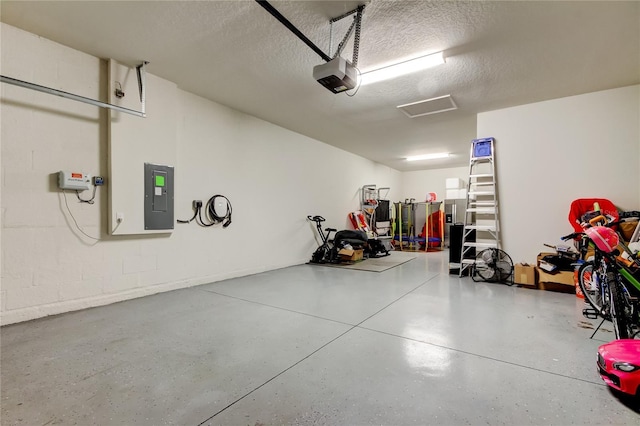 garage featuring electric panel, concrete block wall, and a garage door opener