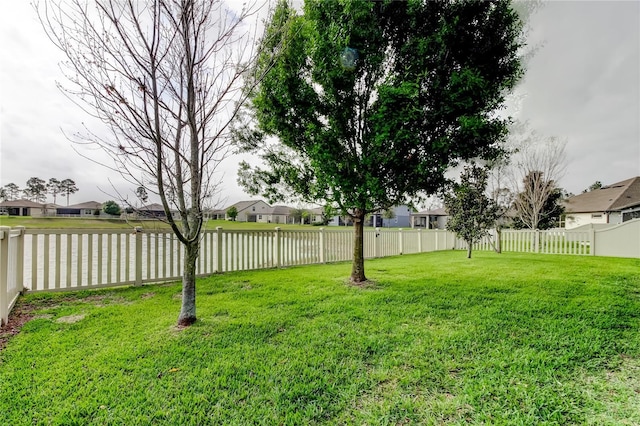 view of yard featuring a residential view and a fenced backyard