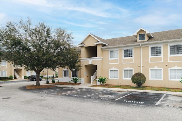 view of property featuring uncovered parking