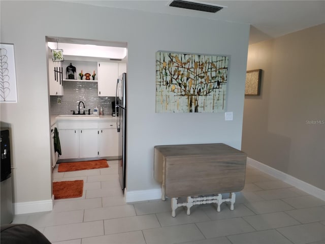 kitchen featuring open shelves, a sink, visible vents, and white cabinets