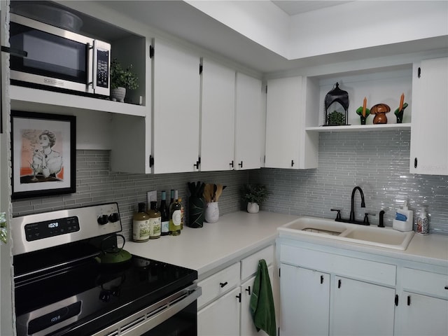 kitchen featuring stainless steel appliances, white cabinets, light countertops, and open shelves