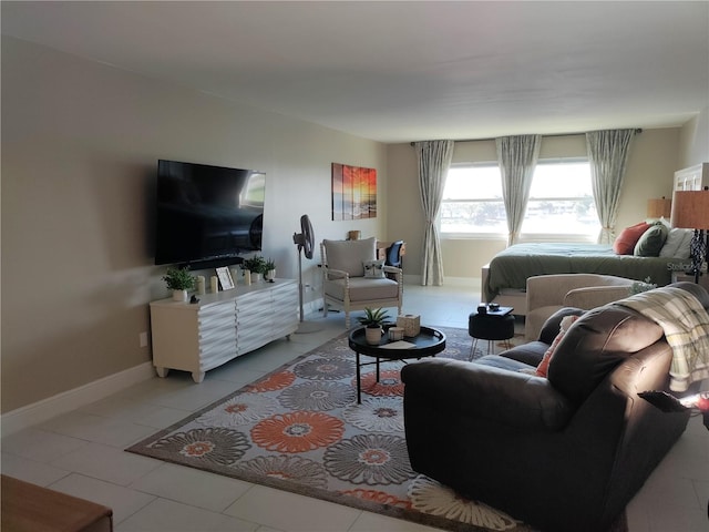 living room with light tile patterned floors and baseboards