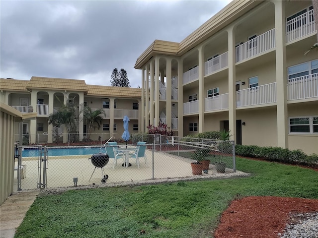 surrounding community featuring a yard and a pool