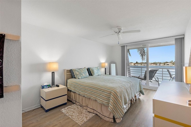 bedroom with ceiling fan, light wood-style flooring, and access to exterior