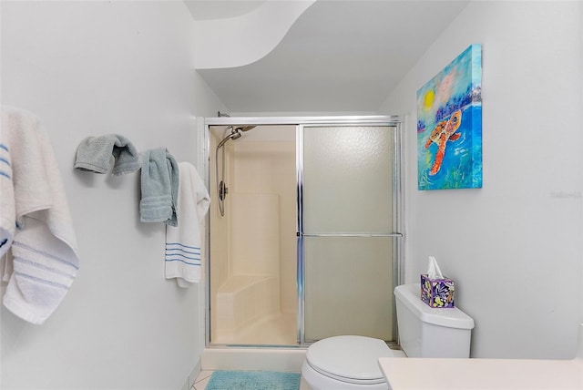 full bathroom with a stall shower and toilet