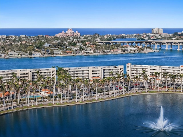 birds eye view of property with a water view and a city view