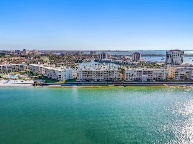 birds eye view of property with a water view and a city view