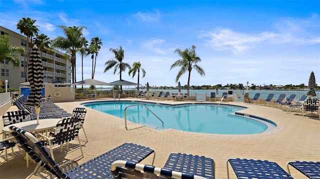 pool with a patio and fence