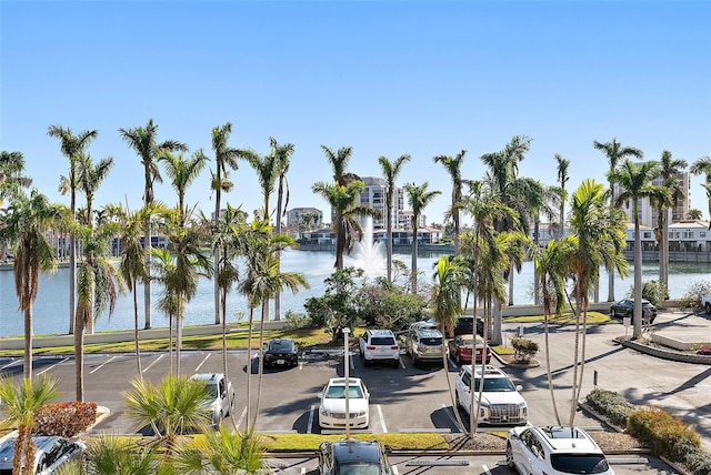 view of street featuring curbs, a water view, and sidewalks