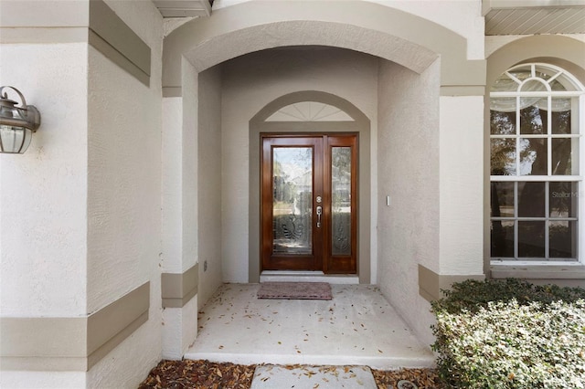 property entrance with stucco siding