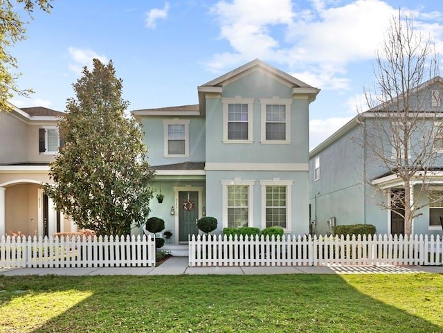 view of front of house featuring a fenced front yard and stucco siding