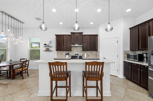 6157 Castleton Hollow Rd, Riverview, FL 33578 - kitchen featuring stainless steel appliances, light countertops, tasteful backsplash, dark brown cabinetry, and a sink