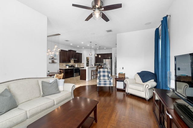 6157 Castleton Hollow Rd, Riverview, FL 33578 - living area with a ceiling fan, light wood finished floors, a chandelier, and recessed lighting