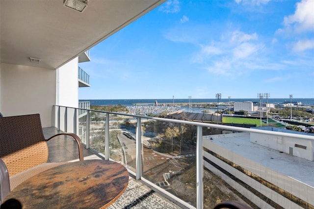 balcony featuring a water view and visible vents