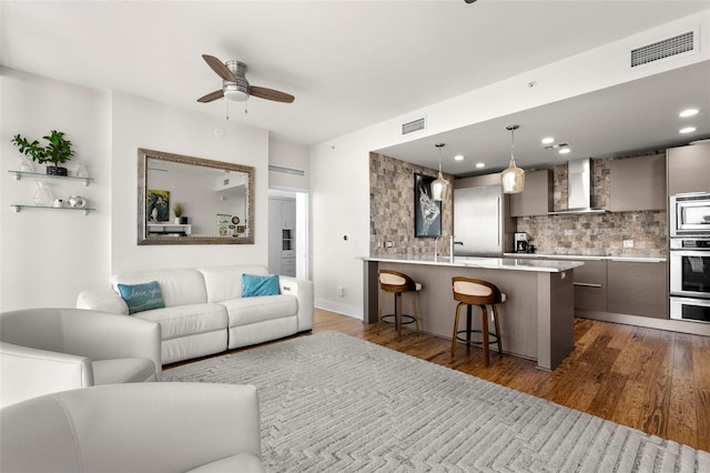 living room featuring dark wood-style floors, recessed lighting, visible vents, and a ceiling fan